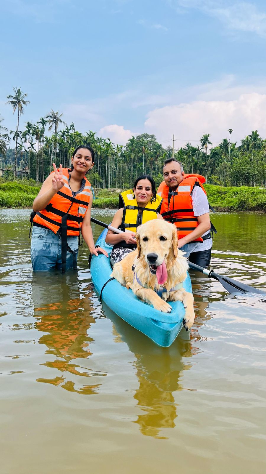 A family walking with their dog along a Coorg coffee plantation trail