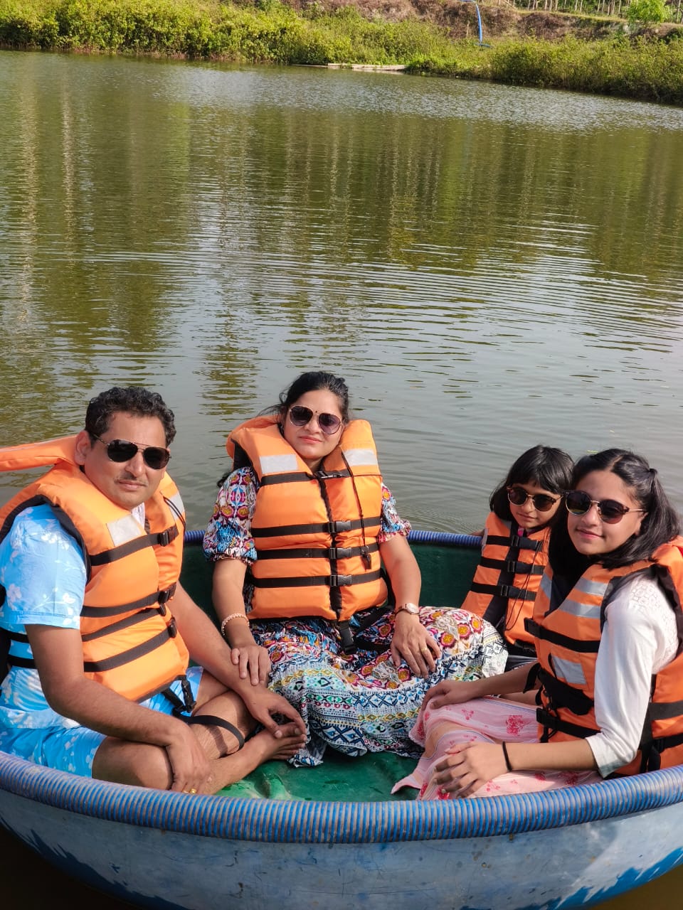 Family riding a coracle together on the lake