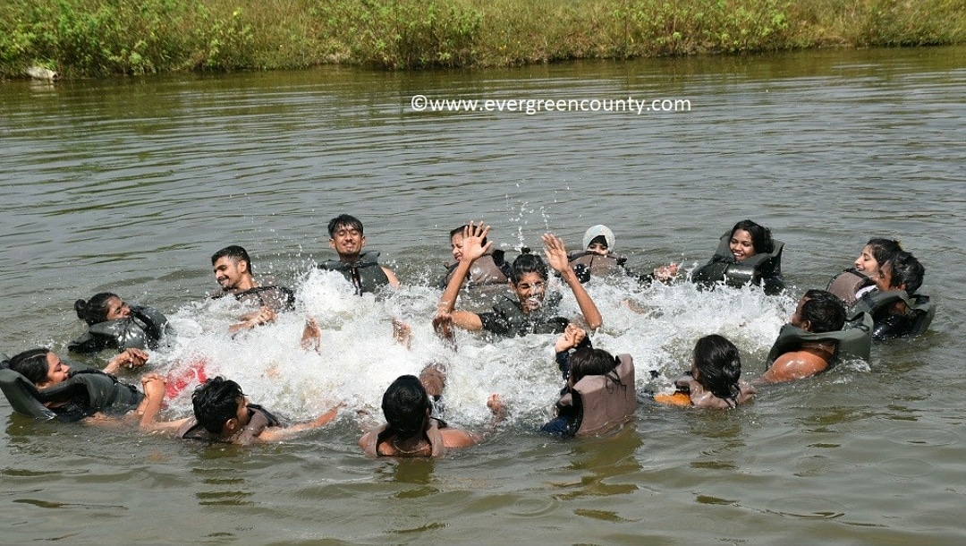 Guests splashing together while pond swimming