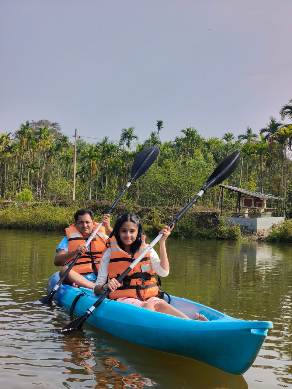 Father and daughter kayaking on the Evergreen pond