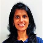 Neethashree, Digital Marketing and Communications lead at Evergreen County retreat, smiling in a natural outdoor setting.